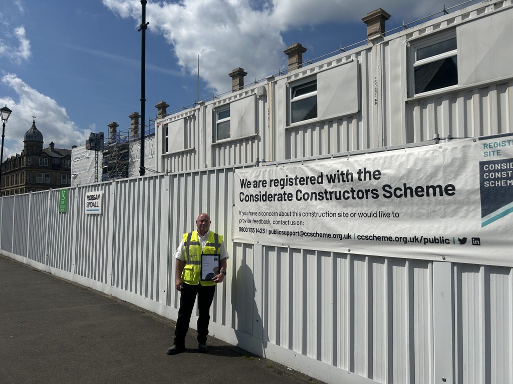 Person in high vis vest outside construction site