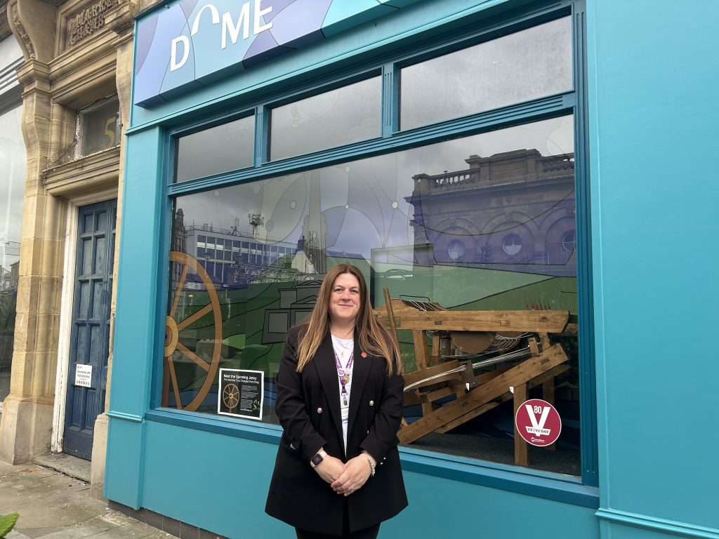 Person stood infront of shop front