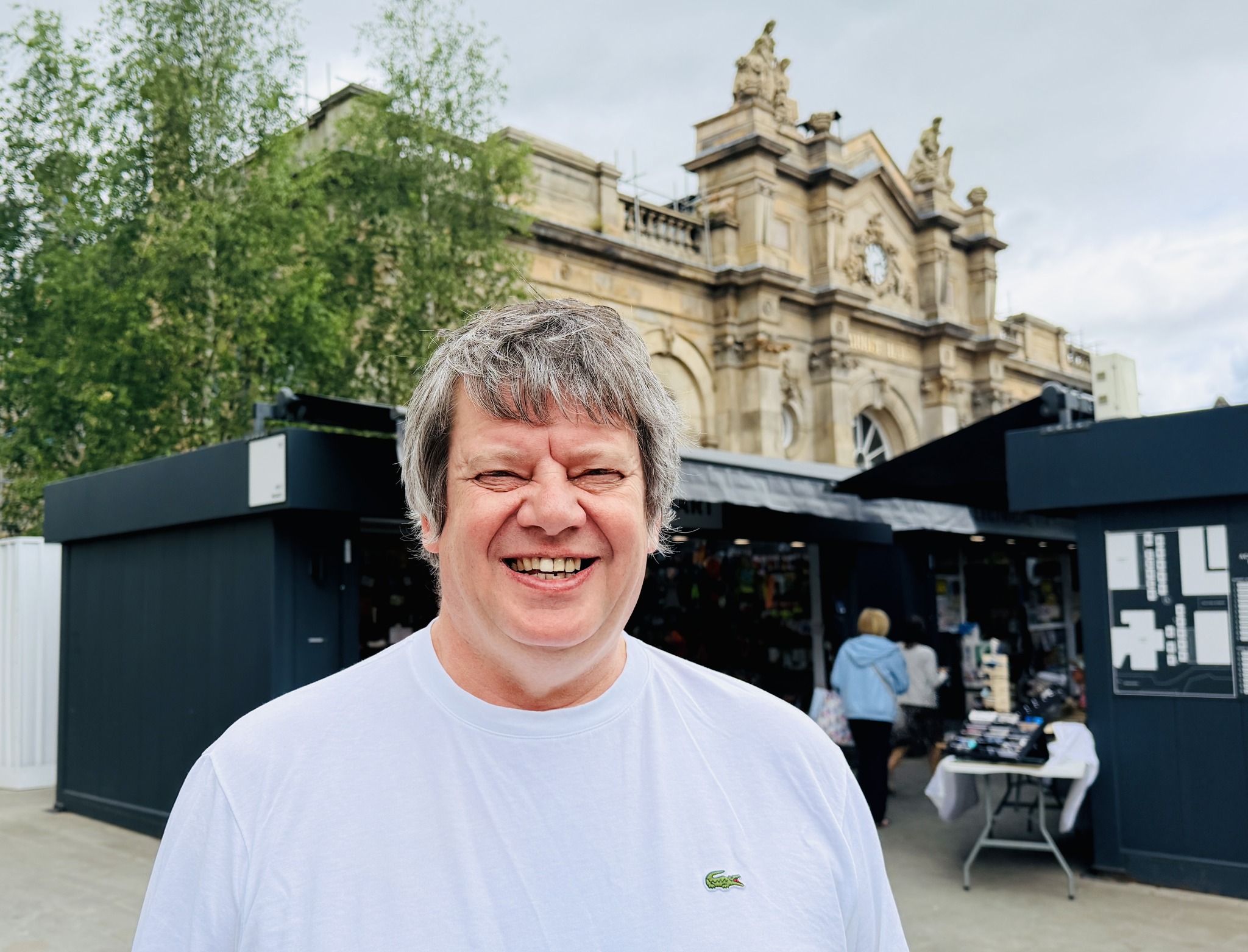 Person with market stalls in background